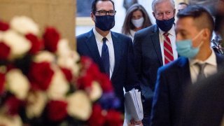 Treasury Secretary Steven Mnuchin, center, and President Donald Trump's Chief of Staff Mark Meadows, right, walks into the office of House Speaker Nancy Pelosi of Calif., on Capitol Hill in Washington, Wednesday, July 29, 2020, for a meeting with Pelosi and Senate Minority Leader Sen. Chuck Schumer of N.Y.