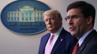 Secretary of Defense Mark Esper speaks as President Donald Trump listens during a White House coronavirus press briefing, April 1, 2020, in Washington, D.C.