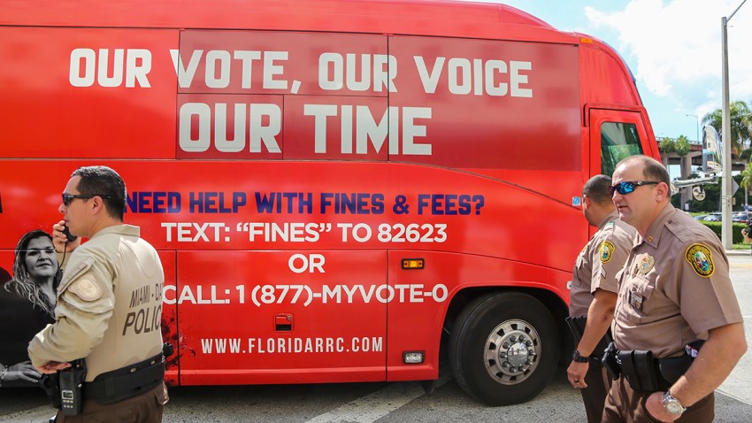 A tour bus sponsored by the Florida Rights Restoration Coalition pulls up to a Miami-Dade County courthouse ahead of a hearing aimed at restoring the right to vote under Florida's Amendment 4 in a Miami-Dade County courtroom, Nov. 8, 2019, in Miami, Fla.