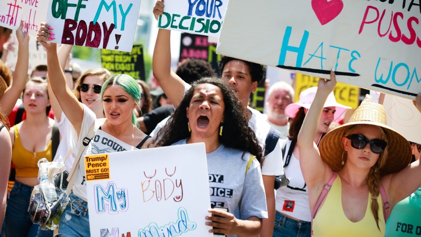Demonstrators hold signs during a protest against Georgia's "heartbeat" abortion bill outside of the Georgia State Capitol building in Atlanta, Georgia, U.S., on Saturday, May 25, 2019. People gathered to protest the state's recently passed House Bill 481, which would ban abortion after a doctor can detect a fetal heartbeat usually around the sixth week of pregnancy.