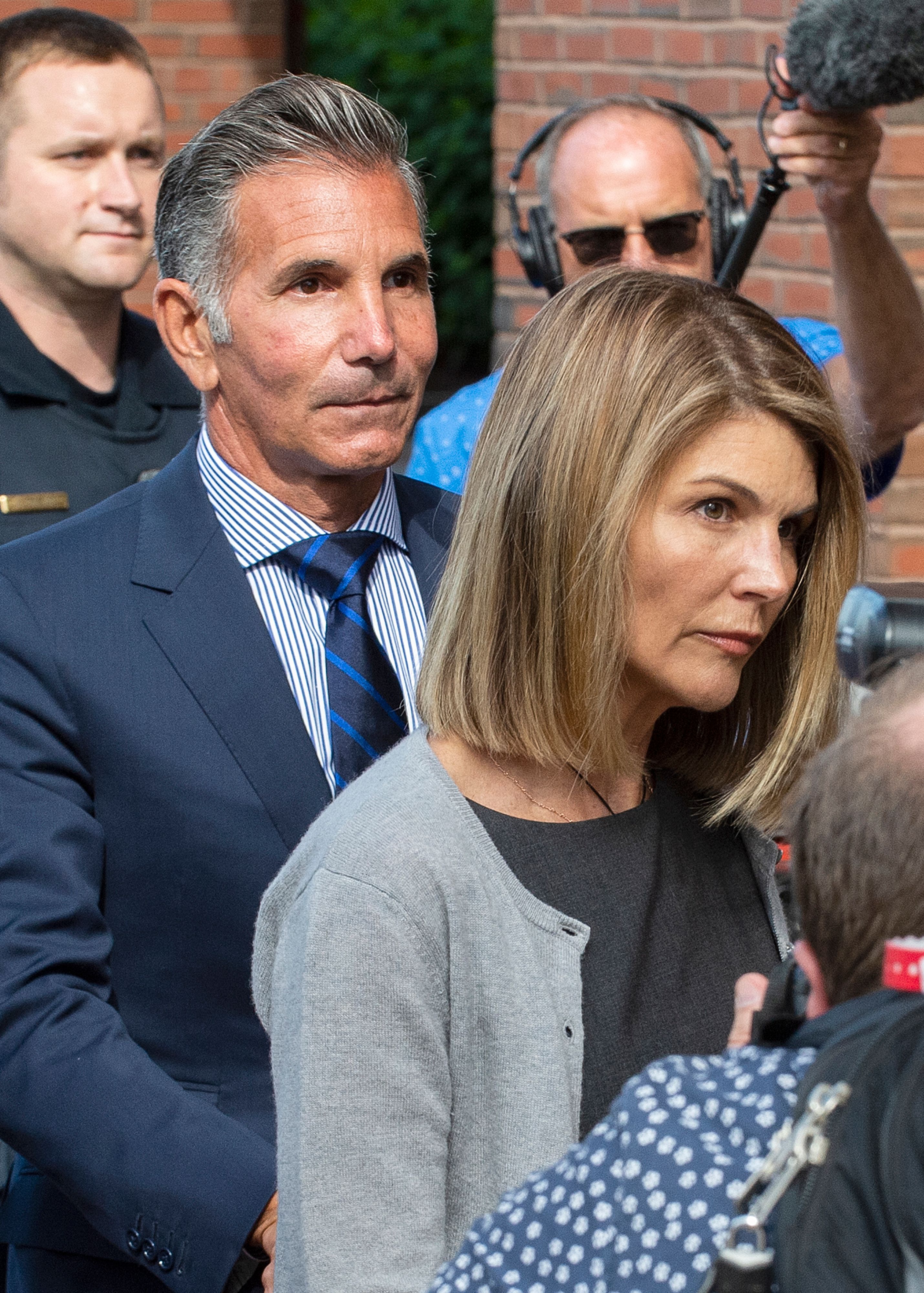 This Aug. 27, 2019, file photo shows actress Lori Loughlin and husband Mossimo Giannulli exit the Boston Federal Court house after a pre-trial hearing.