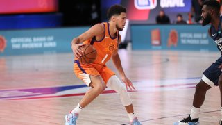 Devin Booker #1 of the Phoenix Suns handles the ball during the game against the Dallas Mavericks on August 2, 2020 at The Visa Athletic Center at ESPN Wide World Of Sports Complex in Reunion, Florida.