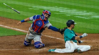 Catcher Jose Trevino #56 of the Texas Rangers tags out Braden Bishop #5 of the Seattle Mariners on a fielder’s choice hit by J.P. Crawford #3 during the sixth inning of a game at T-Mobile Park on August, 21, 2020 in Seattle, Washington.
