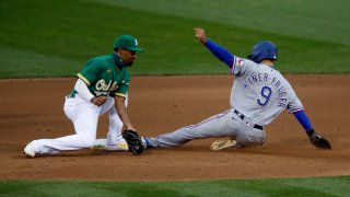 Isiah Kiner-Falefa #9 of the Texas Rangers steals second base ahead of the tag by Marcus Semien #10 of the Oakland Athletics in the top of the fourth inning at Oakland-Alameda County Coliseum on August 05, 2020 in Oakland, California.