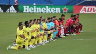 FC Dallas Team (R) and Nashville SC Team get to their knees during the national anthem prior the game game between FC Dallas and Nashville SC as part of the Major League Soccer 2020 at Toyota Stadium on August 12, 2020 in Frisco, Texas.