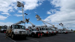 Electric utility trucks are staged along Lake Pontchartrain as in preparation for Tropical Storms Marco and Laura on August 24, 2020 in Kenner, Louisiana.