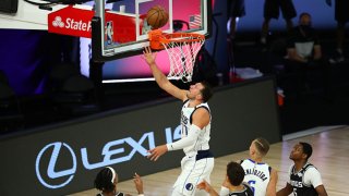 Luka Doncic #77 of the Dallas Mavericks shoots against the Sacramento Kings in the second half of a NBA basketball game at HP Field House at ESPN Wide World Of Sports Complex on Aug. 4, 2020 in Lake Buena Vista, Florida.