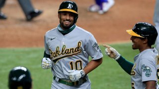 Marcus Semien #10 of the Oakland Athletics celebrates with Tony Kemp #5 of the Oakland Athletics after hitting a two-run home run against the Texas Rangers in the top of the fifth inning at Globe Life Field on Aug. 25, 2020 in Arlington, Texas.