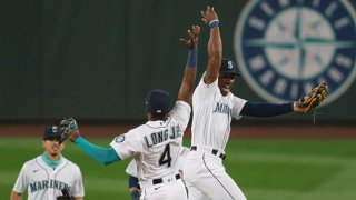 Kyle Lewis #1 (R), Shed Long Jr. #4 and Sam Haggerty #28 of the Seattle Mariners celebrate after a game against the Texas Rangers at T-Mobile Park on August, 22, 2020 in Seattle, Washington. The Mariners won 10-1.