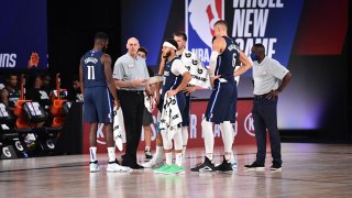 The Dallas Mavericks huddle up during a game against the Phoenix Suns on August 2, 2020 at Visa Athletic Center at ESPN Wide World Of Sports Complex in Orlando, Florida.
