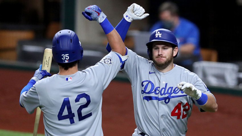 Max Muncy #42 of the Los Angeles Dodgers celebrates with Cody Bellinger #42 of the Los Angeles Dodgers after hitting a three-run home run against the Texas Rangers in the top of the seventh inning at Globe Life Field on Aug. 29, 2020 in Arlington, Texas. All players are wearing #42 in honor of Jackie Robinson Day. The day honoring Jackie Robinson, traditionally held on April 15, was rescheduled due to the COVID-19 pandemic.”