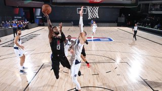 Paul George #13 of the LA Clippers shoots the ball against the Dallas Mavericks during Round One, Game One of the NBA Playoffs on Aug. 17, 2020 at AdventHealth Arena in Orlando, Florida.