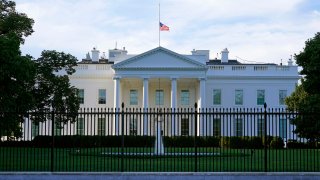 In this Saturday, Sept. 19, 2020, file photo, an American flag flies at half-staff over the White House in Washington.