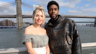 In this Nov. 19, 2019, file photo, Sienna Miller(L) and Chadwick Boseman poses during a photo call for "21 Bridges" at The Fulton in New York City.