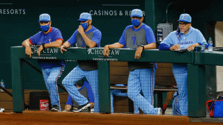 Texas Rangers manager Chris Woodward (8) and his coaching staff watch from the dugout during the game between the Texas Rangers and the Houston Astros on Sept. 27, 2020 at Globe Life Field in Arlington, Texas.