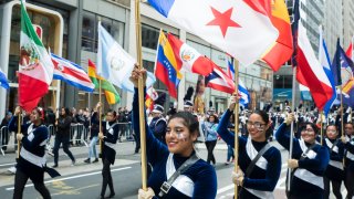 Participants march down 5th Avenue with flags of various Hispanic countries during the 55th Hispanic Day Parade