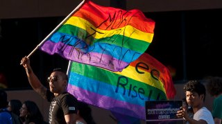 Ignacio Rios, left, of Santa Ana marches with fellow protesters against the detention of transgender women in Santa Ana on Thursday, May 4, 2017.