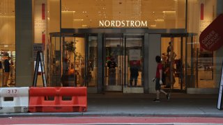 A person walks by Nordstrom flagship store in Midtown Manhattan as New York City moves into Phase 3 of re-opening following restrictions imposed to curb the coronavirus pandemic on July 13, 2020.