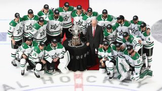 The Dallas Stars pose for a team photo with Bill Daly, the deputy commissioner and chief legal officer of the National Hockey League (NHL) and the Clarence S. Campbell Bowl after winning the Western Conference Championship over the Vegas Golden Knights in Game Five during the 2020 NHL Stanley Cup Playoffs at Rogers Place on September 14, 2020 in Edmonton, Alberta, Canada.