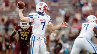 Shane Buechele #7 of the Southern Methodist Mustangs looks to pass under pressure by London Harris #27 of the Texas State Bobcats in the second half at Bobcat Stadium on Sept. 5, 2020 in San Marcos, Texas.