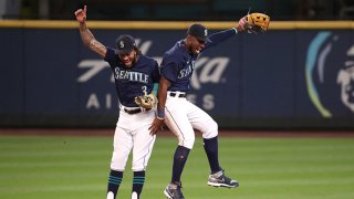 J.P. Crawford #3 (L) and Kyle Lewis #1 of the Seattle Mariners celebrate their 8-4 win against the Texas Rangers at T-Mobile Park on Sept. 7, 2020 in Seattle, Washington.