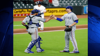 Kyle Gibson #44 of the Texas Rangers hugs Jeff Mathis #2 after pitching a complete game win over the Houston Astros at Minute Maid Park on September 16, 2020 in Houston, Texas.