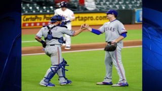 Kyle Gibson #44 of the Texas Rangers hugs Jeff Mathis #2 after pitching a complete game win over the Houston Astros at Minute Maid Park on September 16, 2020 in Houston, Texas.