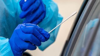 A medical worker administers a rapid COVID-19 test in Oakland, California, Oct. 12, 2020.