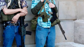 Armed protesters demonstrate during the Michigan Conservative Coalition organized "Operation Haircut" outside the Michigan State Capitol