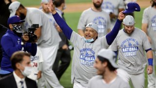 Manager Dave Roberts of the Los Angeles Dodgers celebrates with his team following their 4-3 victory against the Atlanta Braves in Game Seven of the National League Championship Series at Globe Life Field on October 18, 2020 in Arlington, Texas.