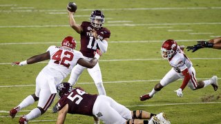 Kellen Mond #11 of the Texas A&M Aggies throws a pass under pressure by Jonathan Marshall #42 of the Arkansas Razorbacks in the first quarter at Kyle Field on Oct. 31, 2020 in College Station, Texas.