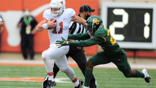 Texas Longhorn QB Sam Ehlinger gets chased by Baylor Bear DB JT Woods (22) during game featuring the Baylor Bears and the Texas Longhorns on October 24, 2020, at Darrell K Royal-Texas Memorial Stadium in Austin, TX.