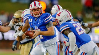 Southern Methodist Mustangs quarterback Shane Buechele (7) looks hand off the football to running back Ulysses Bentley IV (26) during the game between the Southern Methodist Mustangs and the Navy Midshipmen on Oct. 31, 2020 at Gerald Ford Stadium in Dallas, Texas.