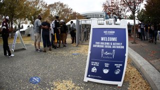Fans wait in line to enter AT&T Stadium for a game between the Dallas Cowboys and the Pittsburgh Steelers on Nov. 8, 2020 in Arlington, Texas.