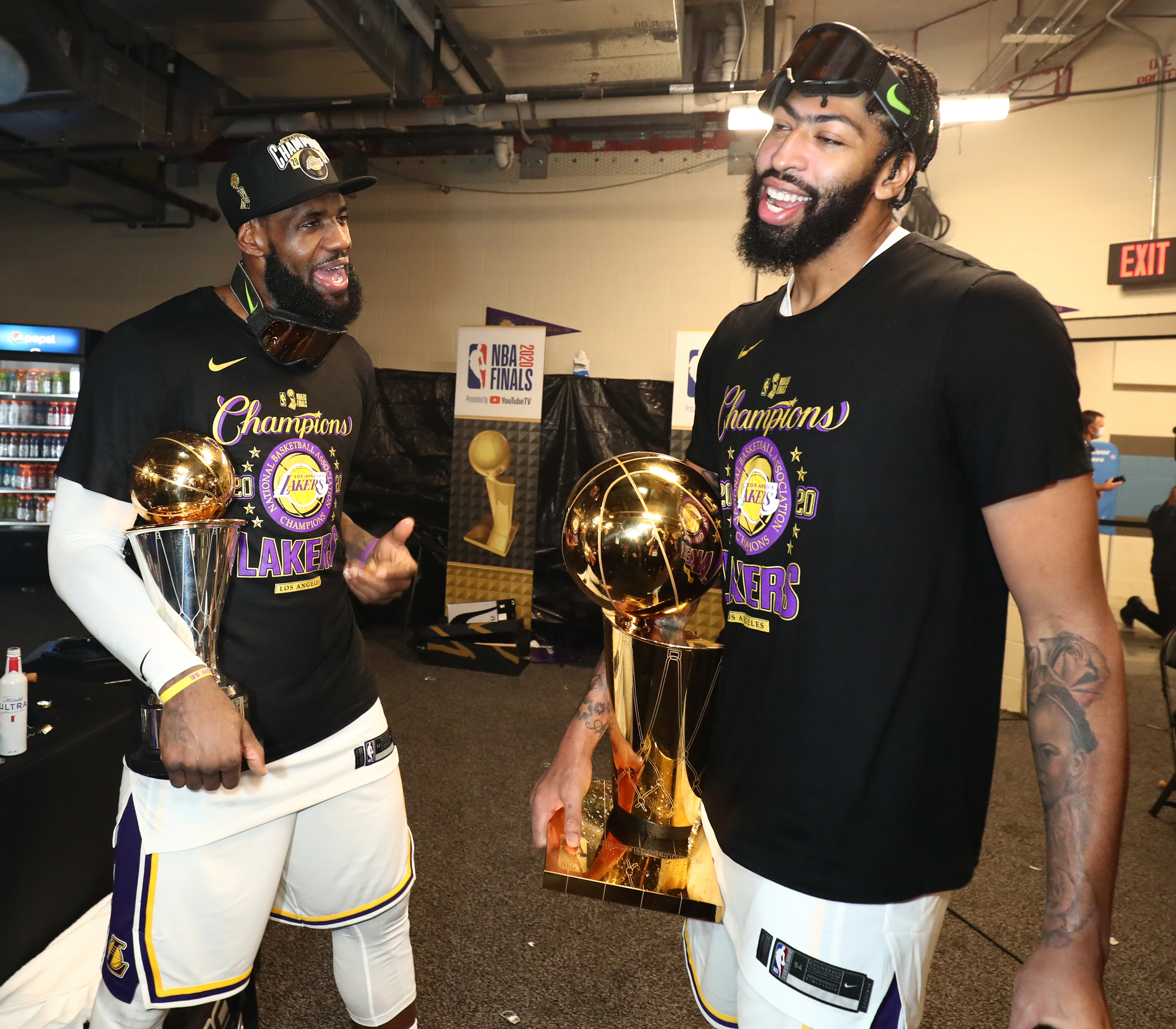 LeBron James #23 and Anthony Davis #3 of the Los Angeles Lakers holds the Larry O’Brien Trophy and The Bill Russell NBA Finals MVP Award in the locker room after winning Game Six of the NBA Finals on October 11, 2020 at AdventHealth Arena in Orlando, Florida. NOTE TO USER: User expressly acknowledges and agrees that, by downloading and/or using this Photograph, user is consenting to the terms and conditions of the Getty Images License Agreement. Mandatory Copyright Notice: Copyright 2020 NBAE (Photo by Nathaniel S. Butler/NBAE via Getty Images)