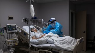 HOUSTON, TX – NOVEMBER 10: (EDITORIAL USE ONLY) A medical staff member treats a patient suffering from coronavirus in the COVID-19 intensive care unit (ICU) at the United Memorial Medical Center (UMMC) on November 10, 2020 in Houston, Texas. According to reports, COVID-19 infections are on the rise in Houston, as the state of Texas has reached over 1,030,000 cases, including over 19,000 deaths. (Photo by Go Nakamura/Getty Images)