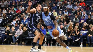 James Johnson #16 of the Minnesota Timberwolves drives to the basket against Aaron Gordon #00 of the Orlando Magic in the first quarter of the game at Target Center on March 6, 2020 in Minneapolis, Minnesota.