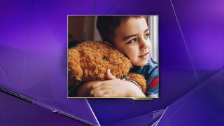 Little Boy Hugging a Teddy Bear