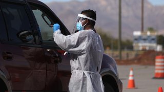 A frontline healthcare worker administers a swab test at a COVID-19 testing site amid a surge of coronavirus cases on Nov. 13, 2020 in El Paso, Texas. Texas eclipsed one million COVID-19 cases November 11th with El Paso holding the most cases statewide. Health officials in El Paso today announced 16 additional COVID-19 related deaths along with 1,488 new cases pushing the virus death toll to 741. Active cases in El Paso are now over 30,000.