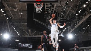 Kristaps Porzingis #6 of the Dallas Mavericks dunks the ball against the LA Clippers during Round One, Game Two of the NBA Playoffs on Aug. 19, 2020 at AdventHealth Arena in Orlando, Florida.