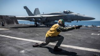 An F/A-18E Super Hornet assigned to the Stingers of Strike Fighter Attack Squadron (VFA) 113 takes off from the flight deck of the aircraft carrier USS Theodore Roosevelt.