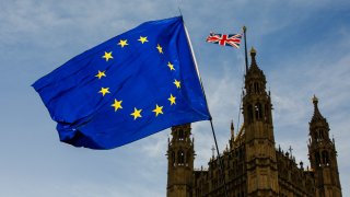 A European Union (EU) flag flies outside the Houses of Parliament in London, U.K., on Thursday, March 7, 2019.