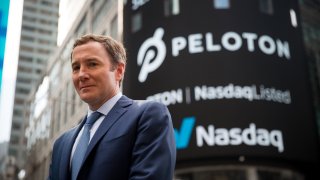 John Foley, co-founder and chief executive officer of Peloton Interactive Inc., stands for a photograph during the company’s initial public offering (IPO) in front of the Nasdaq MarketSite in New York, on Thursday, Sept. 26, 2019.