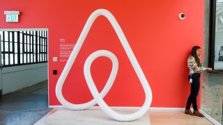 A woman talks on the phone at the Airbnb office headquarters in the SOMA district of San Francisco, California.