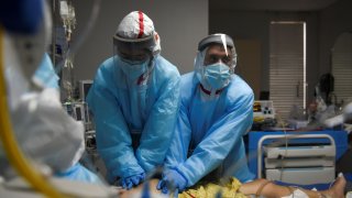 Healthcare personnel perform CPR on a patient inside a coronavirus disease (COVID-19) unit at United Memorial Medical Center as the United States nears 300,000 COVID-19 deaths, in Houston, Texas, U.S., December 12, 2020. Picture taken December 12, 2020.