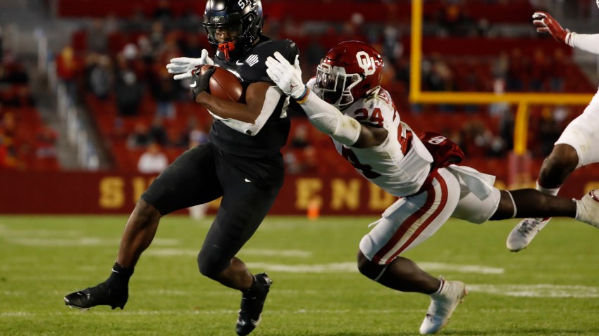 AMES, IA - OCTOBER 3: Running back Breece Hall #28 of the Iowa State Cyclones rushes for yards as linebacker linebacker Brian Asamoah #24 of the Oklahoma Sooners puts pressure on in the first half of the play at Jack Trice Stadium on October 3, 2020 in Ames, Iowa. The Iowa State Cyclones won 37-30 over the Oklahoma Sooners. (Photo by David K Purdy/Getty Images)