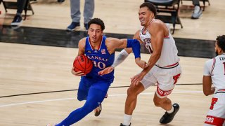 Forward Jalen Wilson #10 of the Kansas Jayhawks handles the ball against forward Marcus Santos-Silva #14 of the Texas Tech Red Raiders during the second half of the college basketball game at United Supermarkets Arena on Dec. 17, 2020 in Lubbock, Texas.