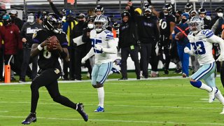 Lamar Jackson runs for a touchdown in the first quarter against the Dallas Cowboys on Tuesday, Dec. 8, 2020 at M&T Bank Stadium in Baltimore, Maryland.