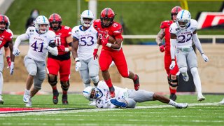 Running back Tahj Brooks #28 of the Texas Tech Red Raiders runs the ball during the second half of the college football game against the Kansas Jayhawks at Jones AT&T Stadium on Dec. 5, 2020 in Lubbock, Texas.
