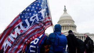 In this Jan. 6, 2021, file photo, supporters of U.S. President Donald Trump hold a rally outside the US Capitol as they protest the upcoming electoral college certification of Joe Biden as US President in Washington, D.C.